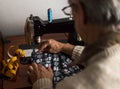 Old man working at the sewing machine Royalty Free Stock Photo