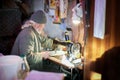 Old man working on sewing machine Royalty Free Stock Photo