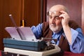 Old man working on a typewriter Royalty Free Stock Photo