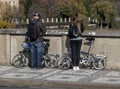 Old Man And Young Woman With Folding Bicycles On Pavement Royalty Free Stock Photo