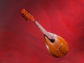 Old mandolin located diagonally on a bright red background. Baroque string musical instrument Royalty Free Stock Photo