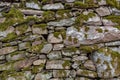 An old manmade stone wall with moss on it Royalty Free Stock Photo