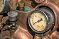 Old manometer a pressure gauge in a copper machine head Royalty Free Stock Photo