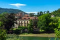 old manor house on river bank against background of high-rise buildings. Spain, Basque Country Royalty Free Stock Photo