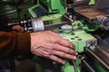 Old mans hand on an old lathe machine Royalty Free Stock Photo