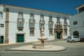 Old mansion in front of deserted square with dry fountain Royalty Free Stock Photo