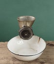 Old manual meat grinder and a white enamel bowl Royalty Free Stock Photo