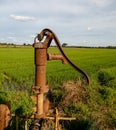 Old manual water pump Lever pump. Vintage cast iron water pump with handle for pumping. Royalty Free Stock Photo