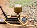 Old manuel spraying pump set made of copper and iron for agriculture, vintage