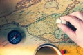 An old map of America with compass, a cup of tea and toy car in hand. Concept of traveling around the country in an old school Royalty Free Stock Photo