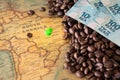 Old map of Brazil with scattered coffee beans and 100 reais banknotes, Concept of the largest coffee producer and exporter in the