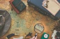 Preparation for the trip. Old map with marked treasure and vintage travel equipment Royalty Free Stock Photo
