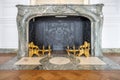 Old marble fireplace with golden forging