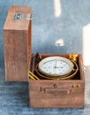 An old marine chronometer in a wooden case