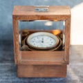 An old marine chronometer in a wooden case Royalty Free Stock Photo