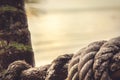 Old marine rope on blurred background of the sunset sky on shore of a tropical sea with palm tree Royalty Free Stock Photo