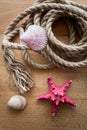 Old marine rope and seashells lying on wooden deck Royalty Free Stock Photo