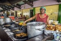 Old market food vendor cooking in Curacao