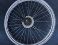 Old massive bike wheel on dark background