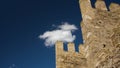 Old massonary of the medeival fortress tower in background of blue skies with some clouds