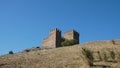 Old massonary of the medeival fortress tower in background of blue skies at top of the hill