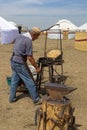 old master blacksmith blows the bellows of a nomadic Kazakh forge Royalty Free Stock Photo
