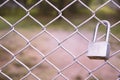 Old master key locked on metal fence Royalty Free Stock Photo