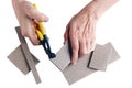 The old master ticks and cut the pieces of floor ceramic tiles. Royalty Free Stock Photo