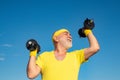 Old mature man exercising with dumbbell. Portrait of senior man holding dumbbell. Old man holding his hands in front of Royalty Free Stock Photo