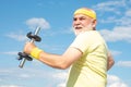 Old mature man exercising with dumbbell. Senior sportsman in sport center. Health club or rehabilitation center for Royalty Free Stock Photo