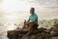 Old mature sportsman enjoying beautiful wild nature after morning jog