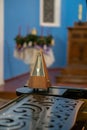 An old mechanical analog metronome stands on the piano. Retro style musical instruments. Concert of piano music in the Catholic