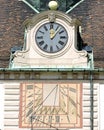 Old Mechanical and Sundial Clock on the roof and facade of a palace in Vienna, Austria