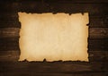 Old mediaeval paper sheet. Horizontal parchment scroll on a wood board Royalty Free Stock Photo