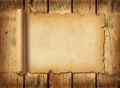 Old mediaeval paper sheet. Horizontal parchment scroll on a wood board Royalty Free Stock Photo