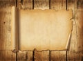 Old mediaeval paper sheet. Horizontal parchment scroll on a wood board Royalty Free Stock Photo