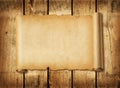 Old mediaeval paper sheet. Horizontal parchment scroll on a wood board Royalty Free Stock Photo