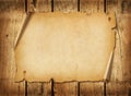 Old mediaeval paper sheet. Horizontal parchment scroll on a wood board Royalty Free Stock Photo