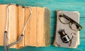 Old medical books with stethoscope, glasses, bottle and key on b Royalty Free Stock Photo