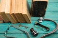 Old medical books with stethoscope, glasses, bottle and key on b Royalty Free Stock Photo