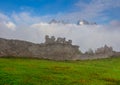 Old medieval castle wall ruin in green mountain valley Royalty Free Stock Photo