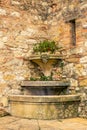 An old medieval fountain in the streets of a village Royalty Free Stock Photo