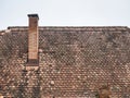 Old medieval house with red brick roof tiles and a chimney in Sighisoara, Romania Royalty Free Stock Photo