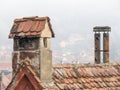 Old medieval house with red brick roof tiles and a chimney in Sighisoara, Romania Royalty Free Stock Photo