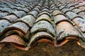 Old medieval house roof made with clay tiles aged by the passage of time Royalty Free Stock Photo