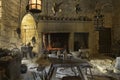 the old kitchen in castle beynac with old pots and pans and wooden furniture