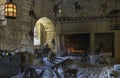 the old kitchen in castle beynac with old pots and pans and wooden furniture