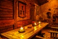 Old medieval restaurant Rozengrals in Riga, Latvia. Candles on wooden tables Royalty Free Stock Photo