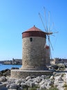 Old medieval windmill near the Mediterranean sea in shore of Rodos Royalty Free Stock Photo