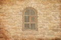 Old medieval window with lattice in brick wall Royalty Free Stock Photo